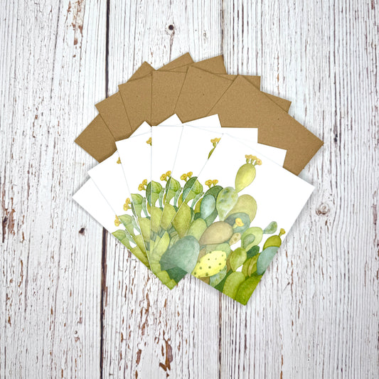 Set of greeting cards with cactus design on a wooden surface